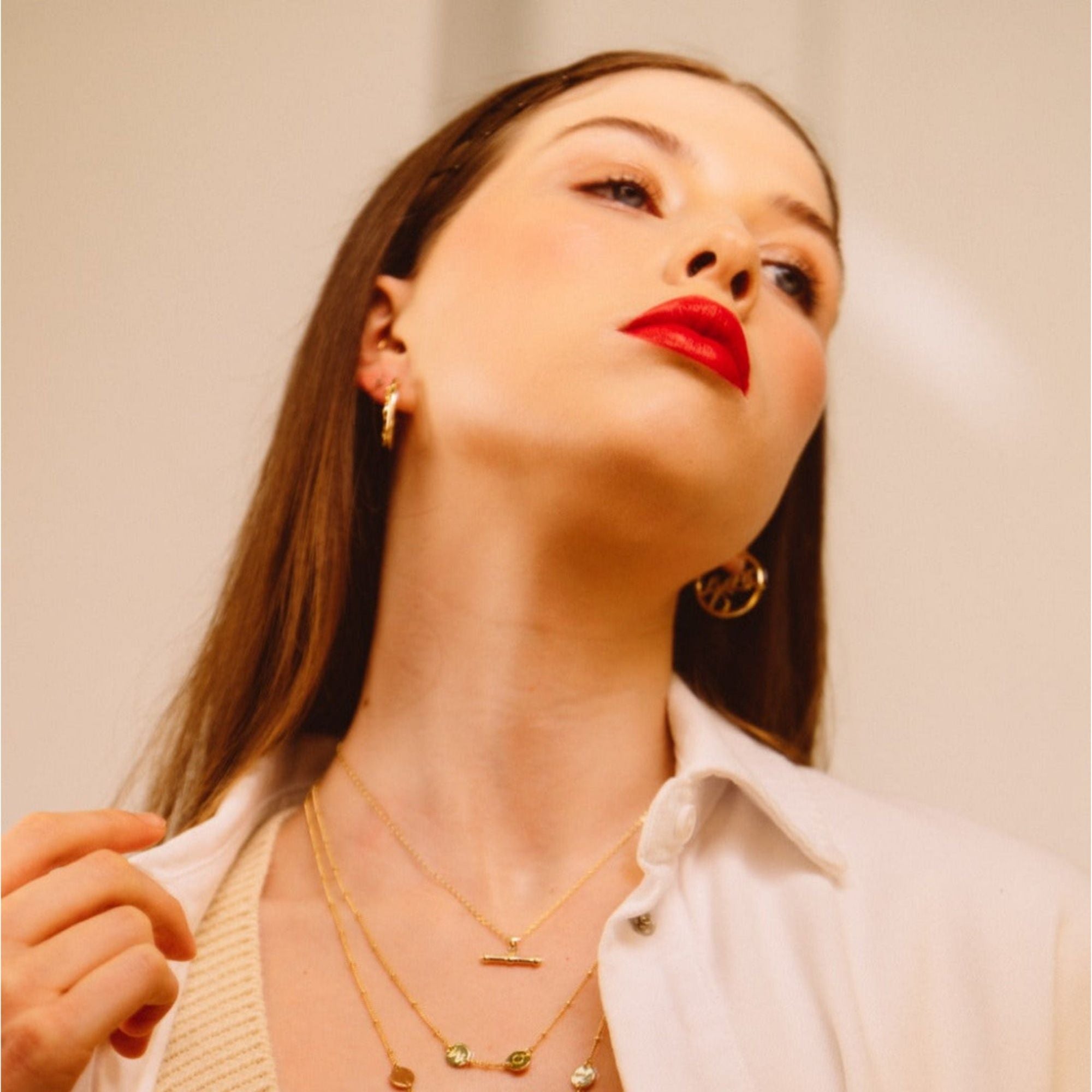 Model wearing Grá Gold Hoop Earrings, Grá means Love in Irish Language. Designed in Ireland