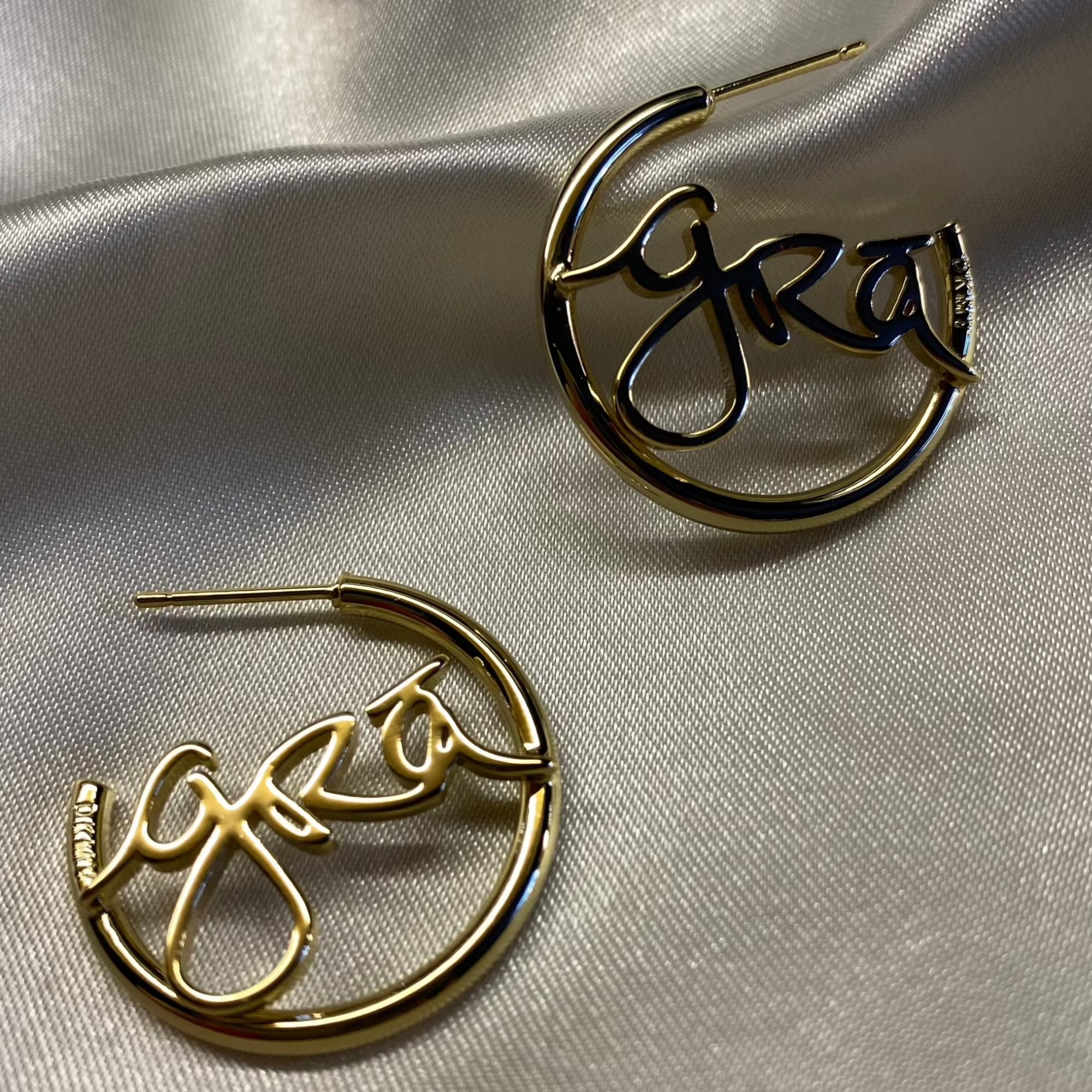 Grá Gold Hoop Earrings on grey silk, Grá means Love in Irish Language. Designed in Ireland