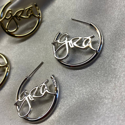 Silver and Gold Grá Beag Hoop Earrings on Grey Silk